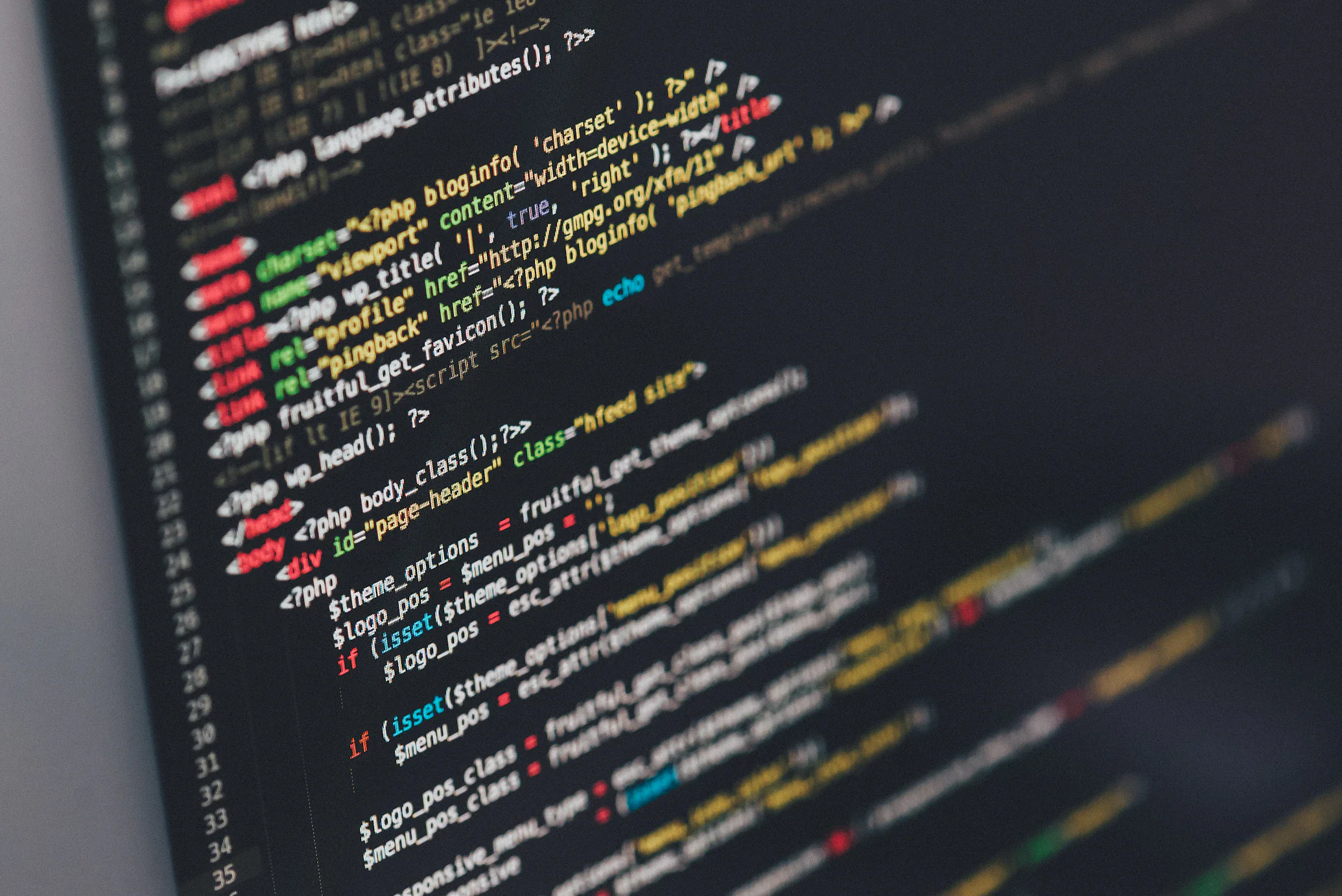 Professional web developer working on multiple monitors with code displaying modern web development environment